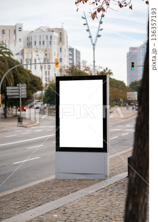 Blank vertical digital screen display mockup in city street, offering advertising space for promotion, marketing, and commercial branding outdoors 136357193