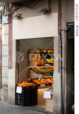 Fruit and vegetable storefront displaying fresh oranges, lemons, kiwi, and other produce in crates, representing local retail and healthy food options 136357228
