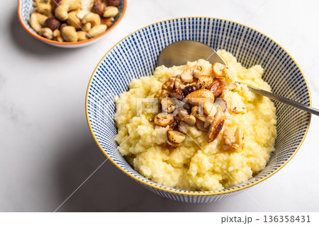 Millet porridge with mixed nuts 136358431