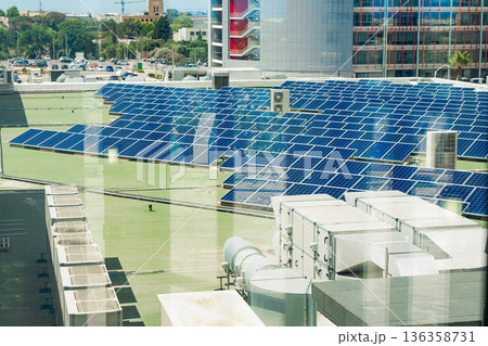 Rooftop solar farm above modern offices, solar output cuts emissions, solar investment fits ESG strategy, sustainable city energy concept for green business, climate content 136358731