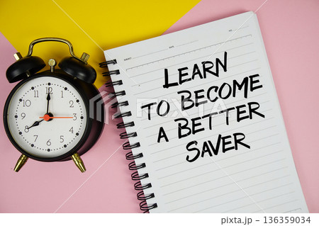 Learn to Become a Better Saver text written on notepad with alarm clock on pink background Learn to Become a Better Saver text written on notepad with alarm clock on pink background 136359034