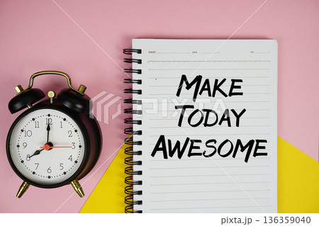 Make Today Awesome text written on notepad with alarm clock on pink background Make Today Awesome text written on notepad with alarm clock on pink background 136359040