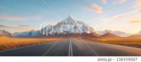 Empty road leading to a majestic snow-capped mountain peak under a blue sky. 136359087