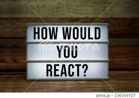 Lightbox with text "How Would You React?" on wooden background 136359727
