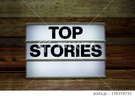Lightbox with text "Top Stories" on wooden background 136359732