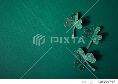 Glitter shamrocks creating festive st. Patrick's day celebration design on green background 136359747