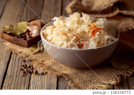 Sauerkraut with ingredients on a rustic background. Sauerkraut with ingredients on a rustic background. 136359773