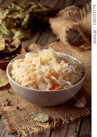 Sauerkraut with ingredients on a rustic background. Sauerkraut with ingredients on a rustic background. 136359774