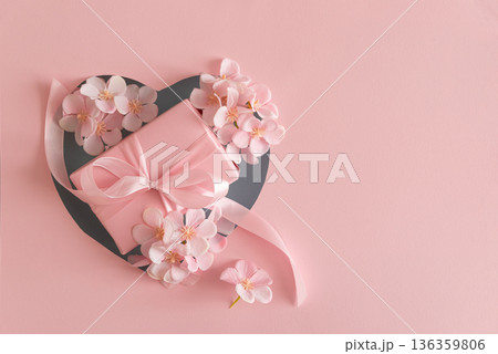 Blue Heart Cutout. Romantic Valentines Day Flatlay with Gift Box and Cherry Blossom on Pink Background Blue Heart Cutout. Romantic Valentines Day Flatlay with Gift Box and Cherry Blossom on Pink Background 136359806
