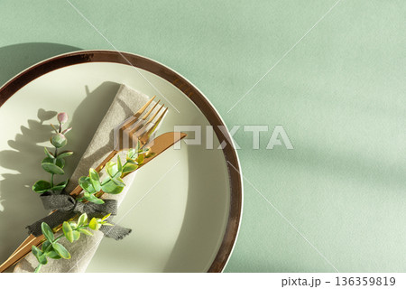 Elegant Table Setting with Napkin and Gold Cutlery. Stylish Easter Spring Arrangement under Sun Light 136359819