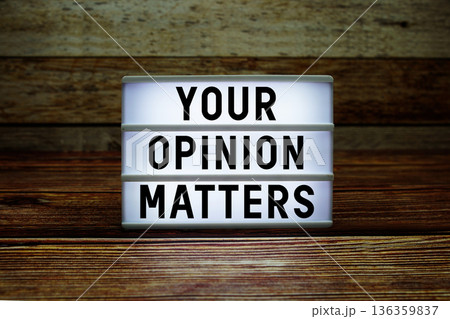 Lightbox with text "Your Opinion Matters" on wooden background 136359837