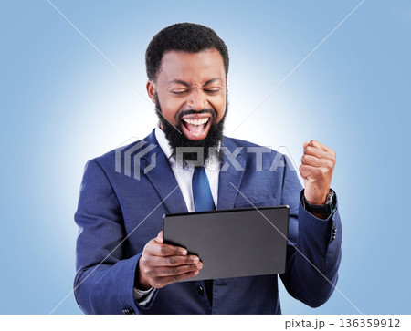 Happy business man, tablet and fist for success in studio for good news, deal and trading bonus. Excited black male trader, digital technology and shout yes for achievement, prize and blue background Happy business man, tablet and fist for success in studio for good news, deal and trading bonus. Excited black male trader, digital technology and shout yes for achievement, prize and blue background 136359912