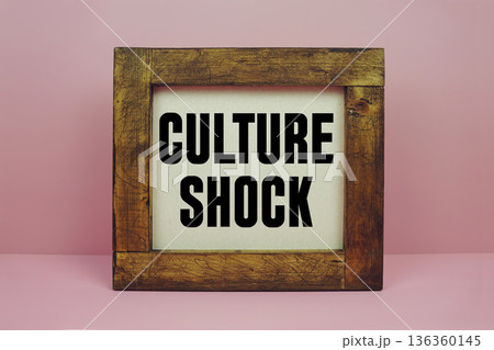 Culture Shock text with brown wooden frame on pink background Culture Shock text with brown wooden frame on pink background 136360145