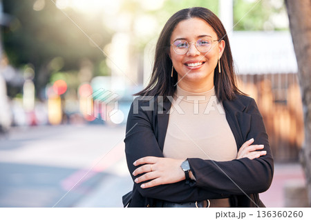 Portrait, designer and woman with arms crossed in city, urban street or outdoor. Face, glasses and confidence of creative professional, employee smile and happy worker from Brazil for business career 136360260