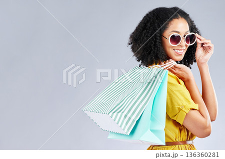 Shopping, bag and woman happy for retail sale, promotion or excited for discount on studio, mockup or grey background. Customer, portrait or girl to shop for fashion or sales on luxury clothing 136360281