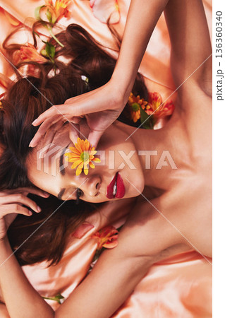 Aesthetic, silk and flowers by a woman with beauty and cosmetic fashion fabric for wellness, glow and skincare. Calm, plants and young female person with luxury makeup or elegant backdrop in spring 136360340