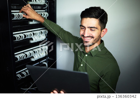 Laptop, maintenance and male technician in a server room for technical repairs by a control box. Technology, engineering and professional man electrician working on computer for cybersecurity system. 136360342