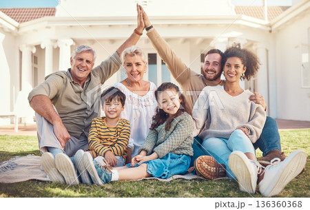 Portrait, high five and a family in the garden of their home together during a visit with grandparents. Diversity, love and children with their parents on a lawn in the backyard for bonding in summer Portrait, high five and a family in the garden of their home together during a visit with grandparents. Diversity, love and children with their parents on a lawn in the backyard for bonding in summer 136360368