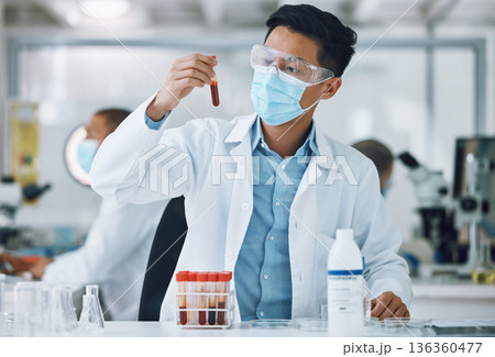 Test, blood sample and scientist doing research with face mask in a laboratory for medical analysis in a lab. Science, medicine and professional Asian man working on exam of DNA in a vial tube Test, blood sample and scientist doing research with face mask in a laboratory for medical analysis in a lab. Science, medicine and professional Asian man working on exam of DNA in a vial tube 136360477