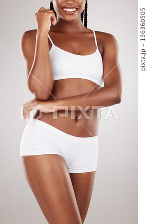 Stomach, body and underwear of a woman for health and wellness on a white studio background. Fitness, glow and skincare of aesthetic female model on a diet for weight loss, balance or motivation Stomach, body and underwear of a woman for health and wellness on a white studio background. Fitness, glow and skincare of aesthetic female model on a diet for weight loss, balance or motivation 136360505