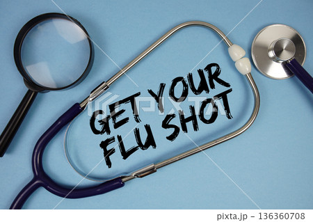 Get Your Flu Shot text with Stethoscope and magnifying glass on blue background 136360708