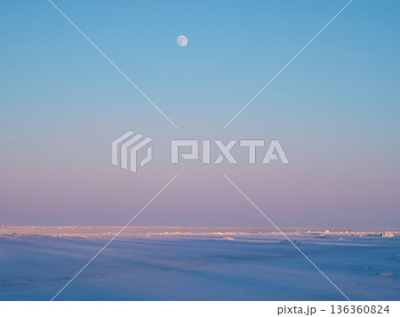The moon rising over the frozen sea. The moon rising over the frozen sea. 136360824