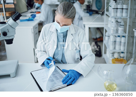 Senior woman, scientist and lab writing for research and notes for medical analysis. Info, investigation and laboratory documents for covid and healthcare report with paperwork and data planning 136360850