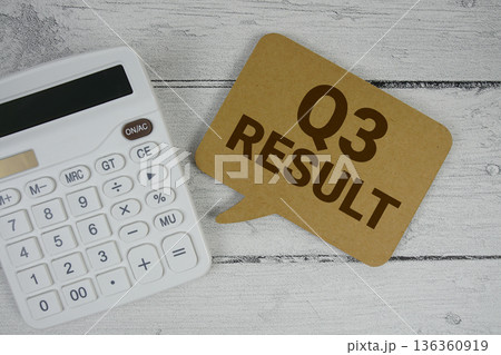 3rd Quarter Financial Report text with calculator on wooden background 136360919