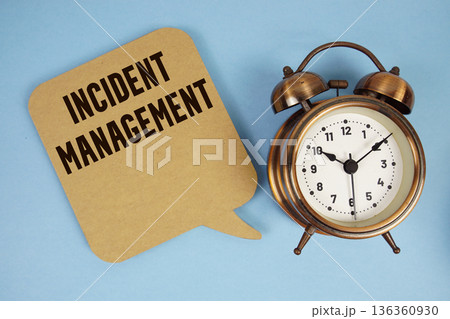 Incident Management text with alarm clock on blue background Incident Management text with alarm clock on blue background 136360930