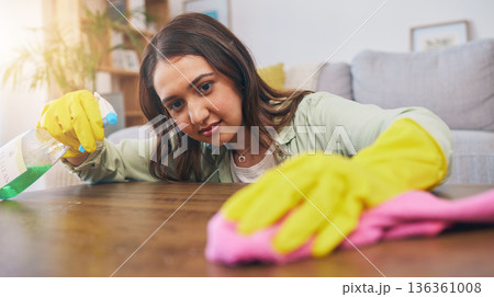 Cleaning table, woman and spray for dust, furniture shine or bacteria on a surface of a house. Smile, working and a girl or cleaner spraying a desk in a living room for housekeeping or home service Cleaning table, woman and spray for dust, furniture shine or bacteria on a surface of a house. Smile, working and a girl or cleaner spraying a desk in a living room for housekeeping or home service 136361008
