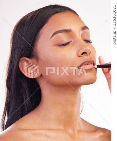 Beauty, makeup and pencil on face of woman in studio for cosmetics, lip liner and product. Salon, self care and glow with female model on white background for application, lipstick and facial Beauty, makeup and pencil on face of woman in studio for cosmetics, lip liner and product. Salon, self care and glow with female model on white background for application, lipstick and facial 136361021