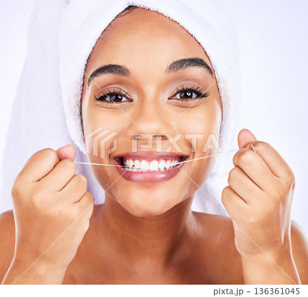 Dental floss, teeth and face of a woman for health and wellness in studio. Portrait of a young female model flossing, cleaning and self care for fresh breath, hygiene and shine on a white background Dental floss, teeth and face of a woman for health and wellness in studio. Portrait of a young female model flossing, cleaning and self care for fresh breath, hygiene and shine on a white background 136361045