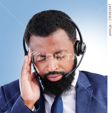 Customer service, studio face and black man headache, stress or sad over telecom fail, salesman crisis or call center burnout. Mental health risk, migraine pain and African person on blue background 136361047
