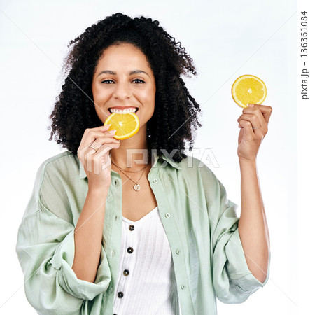 Portrait, orange and woman with a smile, healthy snack and girl isolated against a white studio background. Face, female person or model with fruit, vitamin c and nutrition with happiness or wellness Portrait, orange and woman with a smile, healthy snack and girl isolated against a white studio background. Face, female person or model with fruit, vitamin c and nutrition with happiness or wellness 136361084