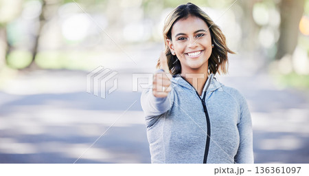 Runner woman, thumbs up and portrait in park, smile or exercise in fitness training in nature. Indian girl, happy and hand for sign language, health or workout for body, wellness or success with goal 136361097