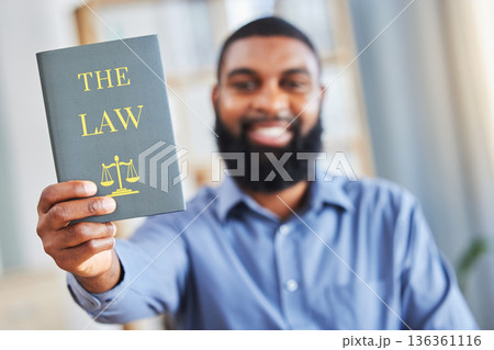 Law, book and happy portrait of a man with the rules or research on legal constitution, regulation or policy from government. African businessman, lawyer or attorney with knowledge of justice 136361116
