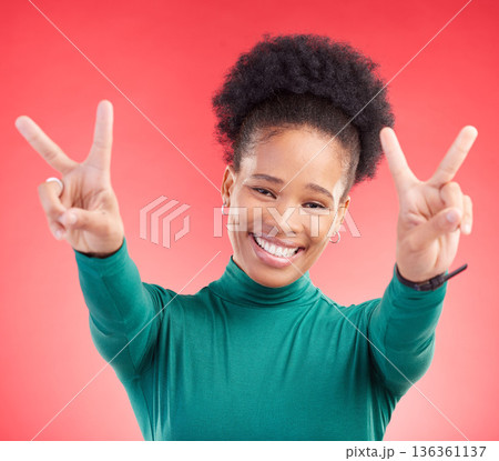 Happy, portrait and black woman with peace hands in studio with thank you, vote or feedback on red background. V, sign and African lady with good vibes, smile and freedom emoji, support or self love Happy, portrait and black woman with peace hands in studio with thank you, vote or feedback on red background. V, sign and African lady with good vibes, smile and freedom emoji, support or self love 136361137