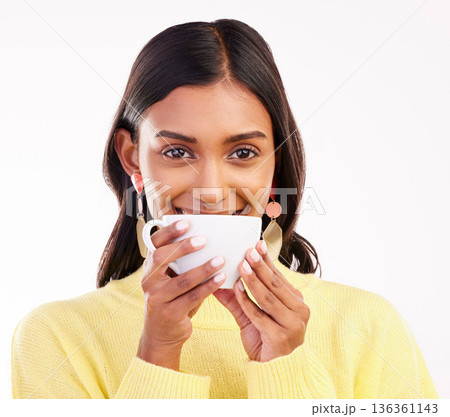 Woman, coffee and smile in studio portrait for fashion, relax or drink for health, energy or aroma by white background. Gen z girl, happy student and cup by face for coco, matcha or espresso in hands 136361143