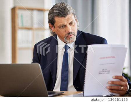 Lawyer, confidential and paperwork with man reading patient file and documents in office. Compliance, legal report and attorney employee in a law firm with government contract and policy planning Lawyer, confidential and paperwork with man reading patient file and documents in office. Compliance, legal report and attorney employee in a law firm with government contract and policy planning 136361156