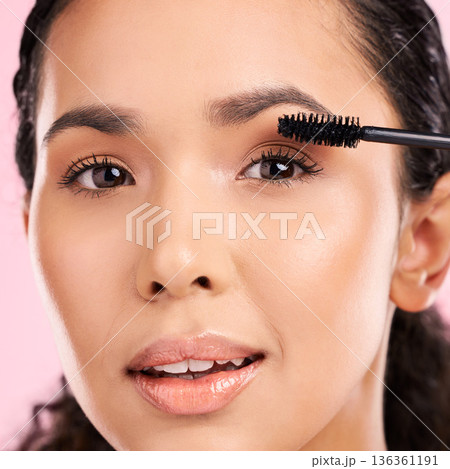 Mascara, beauty and makeup on face of a woman in studio for eyelash cosmetics and natural glow. Portrait, application and skin care tools or product on a female aesthetic model on a pink background Mascara, beauty and makeup on face of a woman in studio for eyelash cosmetics and natural glow. Portrait, application and skin care tools or product on a female aesthetic model on a pink background 136361191