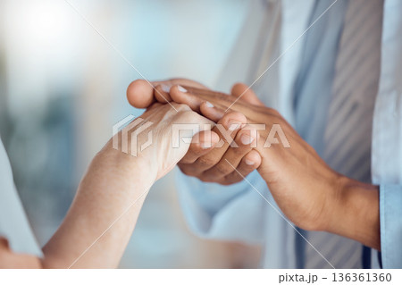 Support, care and hands holding for healthcare trust by doctor with patient for love, help and hope in a hospital. Cancer, medical and closeup of professional with comfort for person in a clinic 136361360