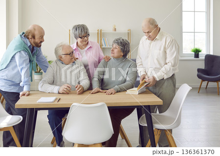 Group of senior people men and women talking in nursing home sitting at the table. 136361370