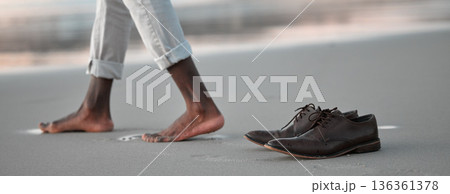 Shoes, walk and beach for business man, freedom and sunset to relax in nature by water after work. Person, ground and ocean with barefoot adventure for vacation, outdoor and steps on sand at dusk 136361378