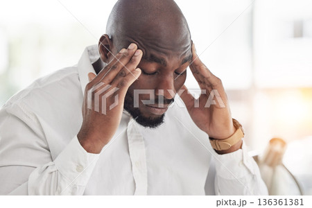 Business man, headache and pain or frustrated in office for financial report, mistake and problem with debt or crisis. Angry, fatigue or tired professional accountant, worker or african person stress 136361381