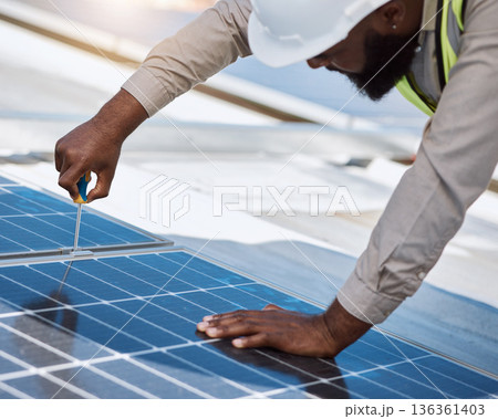 Black man, engineer and repair for solar panel, roof or maintenance for industry, thinking and building. Technician, screwdriver or tools for photovoltaic tech, helmet or sustainable renewable energy Black man, engineer and repair for solar panel, roof or maintenance for industry, thinking and building. Technician, screwdriver or tools for photovoltaic tech, helmet or sustainable renewable energy 136361403