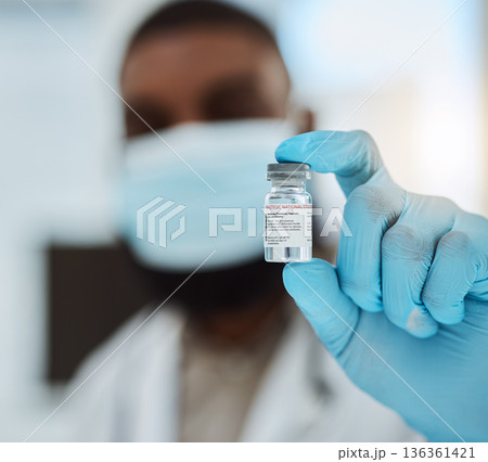 Medicine, vaccine and a hand of a doctor with gloves for virus protection, healthcare or cure in hospital. Person with pharmaceutical product, vial or container for treatment, solution or prevention Medicine, vaccine and a hand of a doctor with gloves for virus protection, healthcare or cure in hospital. Person with pharmaceutical product, vial or container for treatment, solution or prevention 136361421