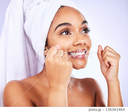 Tooth, oral care and woman with dental floss in studio for fresh breath, wellness or beauty routine on grey background. Mouth, cleaning and female flossing for cavity, protection and teeth whitening 136361464