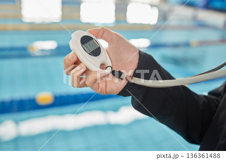 Stopwatch, training and hands of coach at swimming pool for sports, workout and fitness tracker. Personal trainer, exercise and competition with closeup of person and timer for check and cardio Stopwatch, training and hands of coach at swimming pool for sports, workout and fitness tracker. Personal trainer, exercise and competition with closeup of person and timer for check and cardio 136361488