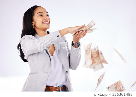 Money, rain and a woman lottery winner in studio on a white background in celebration of a bonus or promotion. Cash, finance and payment with a happy young female excited about investment growth Money, rain and a woman lottery winner in studio on a white background in celebration of a bonus or promotion. Cash, finance and payment with a happy young female excited about investment growth 136361489