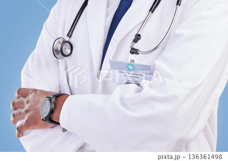 Doctor, stethoscope and arms crossed in studio with a medical expert or healthcare worker on blue background. Surgeon, hands and confidence in medicine or pharmaceutical research in hospital Doctor, stethoscope and arms crossed in studio with a medical expert or healthcare worker on blue background. Surgeon, hands and confidence in medicine or pharmaceutical research in hospital 136361498